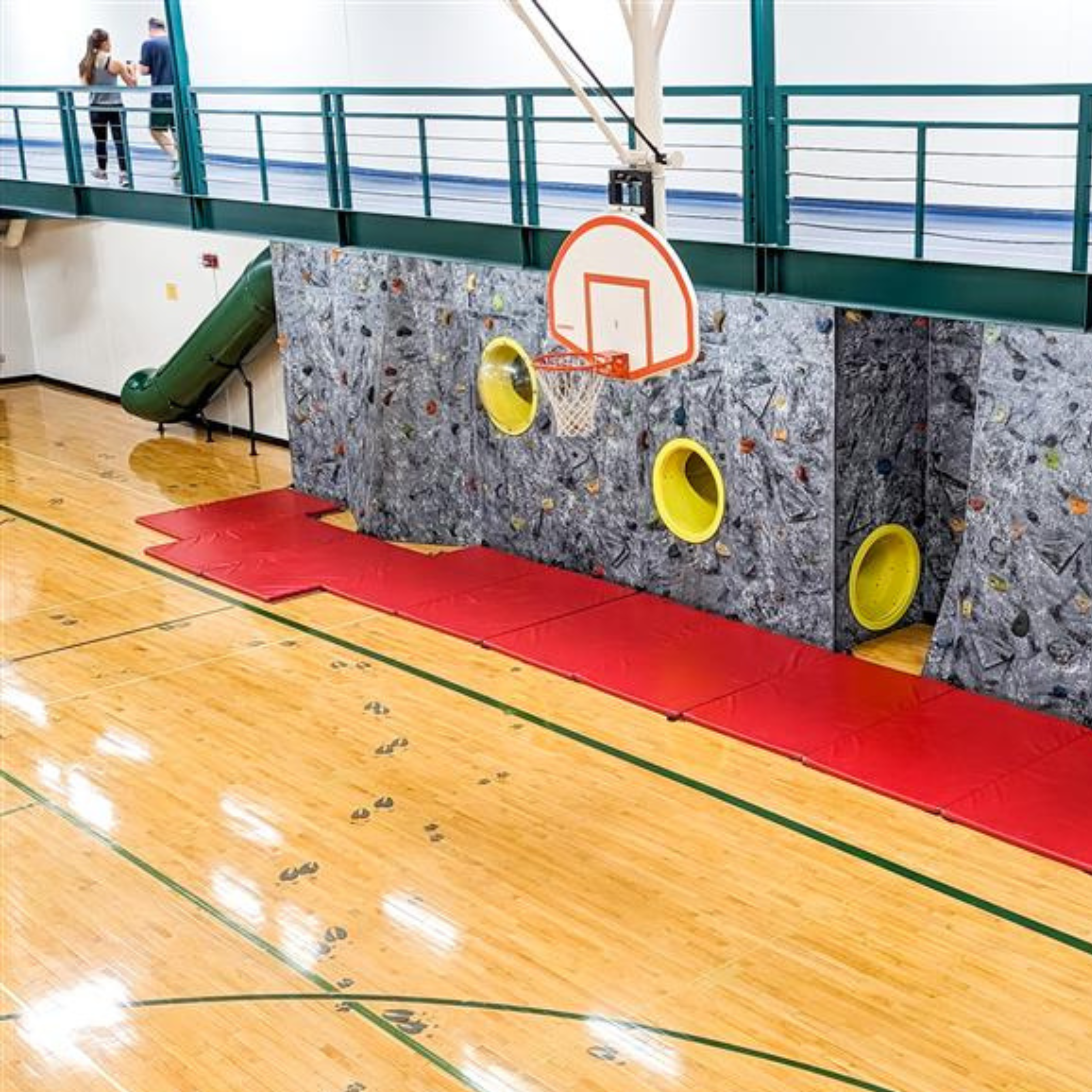 Upper gym featuring climbing wall, tunnels, and tubes